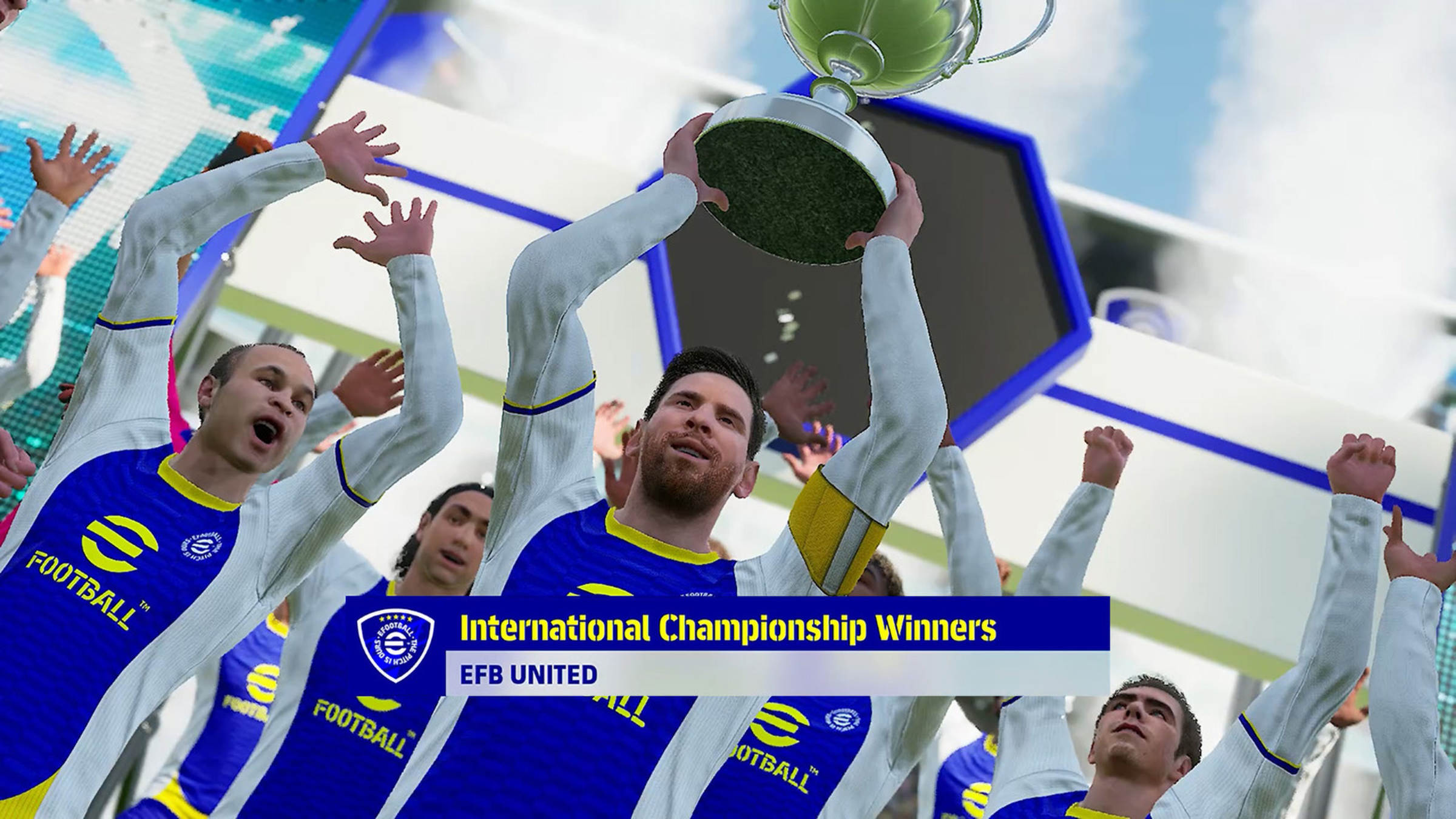 Jugadores de EFB United levantando un trofeo bajo el cartel “International Championship Winners”