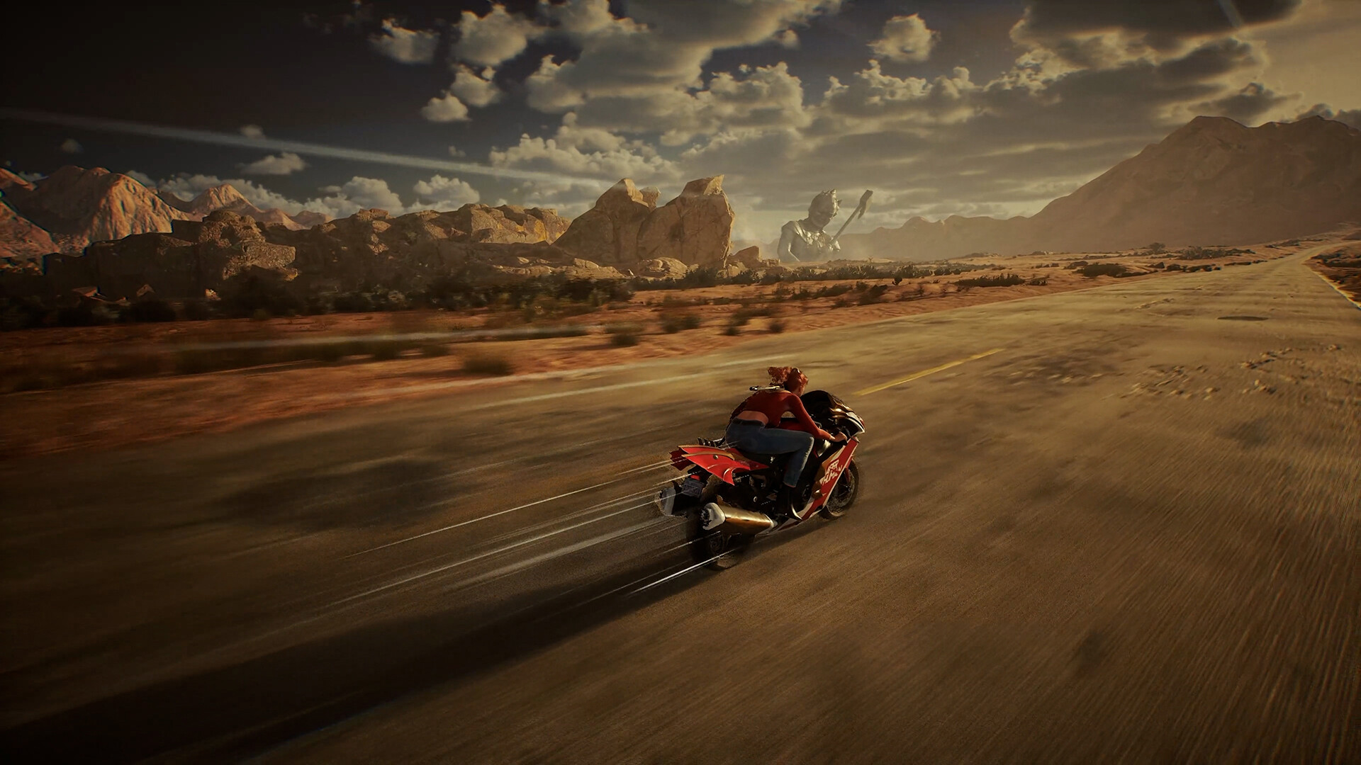Choko riding a motorcycle down a desert road, with a giant statue in the distance