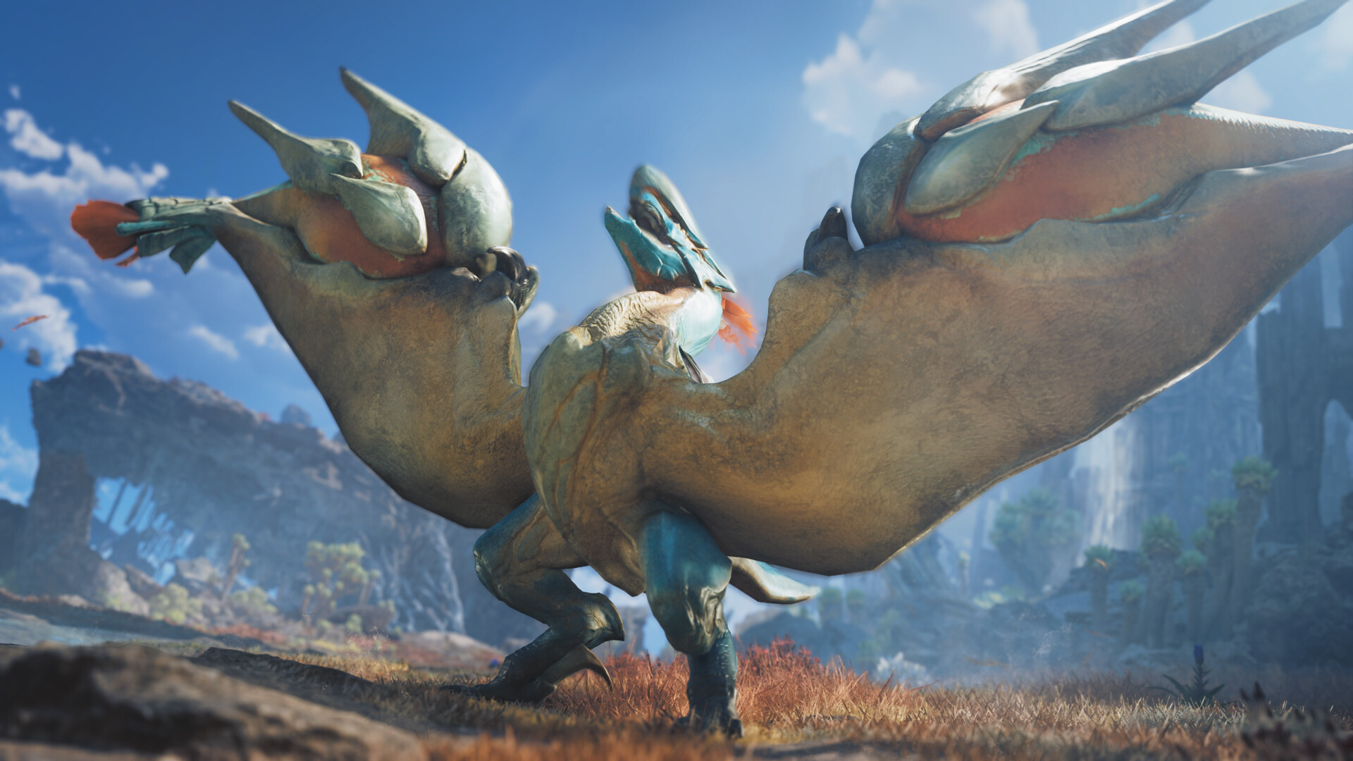 A winged monster stands on reddish grass with its wings spread wide