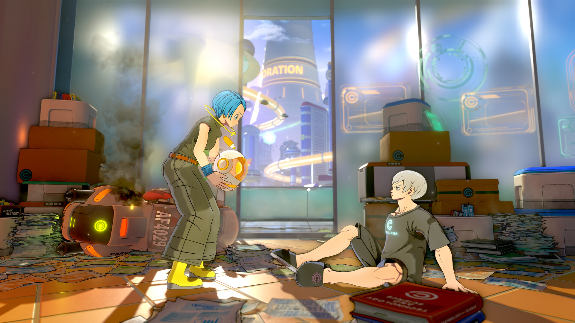 A blue-haired woman holding a round robot and a white-haired young man in a “Capsule Corp.” T-shirt sitting on the floor, in a room littered with papers and boxes